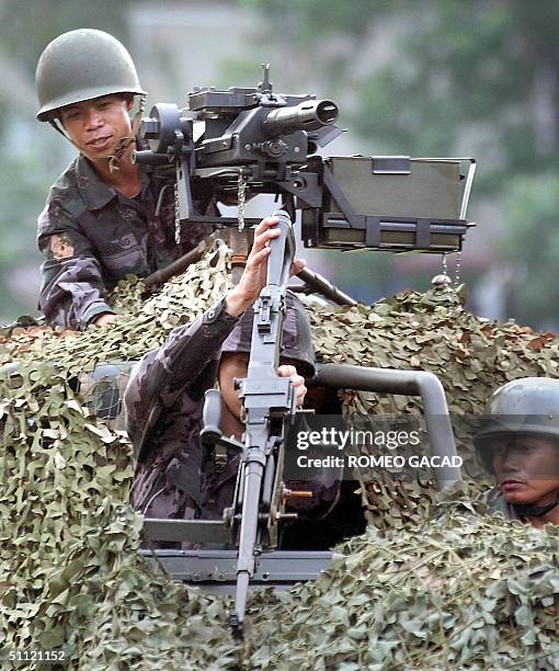 Team of police commandos displays its firepower mounted on a camouflaged jeep during graduation rites for the 155 police personnel who completed the...