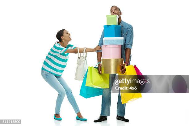 female dragging male to do more shopping - shopping disappointment stock pictures, royalty-free photos & images
