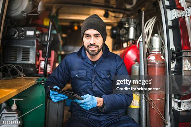 mechanic technician on a garage - plumber van stock pictures, royalty-free photos & images