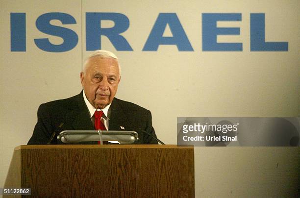 Israeli Prime Minister Ariel Sharon welcomes French Jewish immigrants July 28, 2004 on their arrival at Israel's Ben Gurion Airport near Tel Aviv....