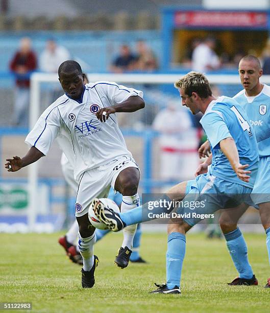 Tcham N'toya of Chesterfield is challenged by Danny Livesey of Bolton during the pre-season friendly match between Chesterfield and Bolton Wanderers...