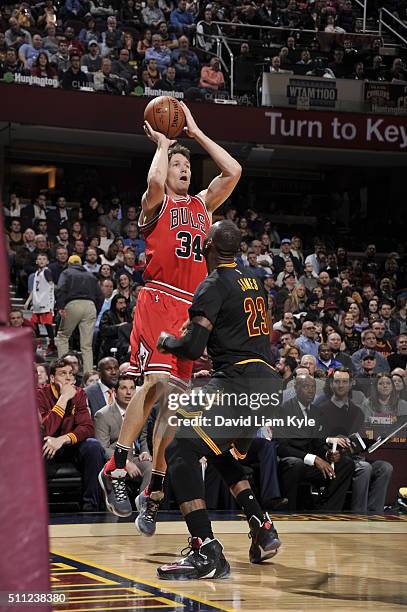 Mike Dunleavy of the Chicago Bulls shoots against LeBron James of the Cleveland Cavaliers on February 18, 2016 at Quicken Loans Arena in Cleveland,...