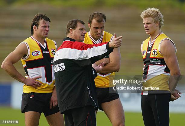 Grant Thomas coach of the Saints talks with players Aaron Hamill, Fraser Gehrig and Nick Riewoldt during the St.Kilda Saints training session at...