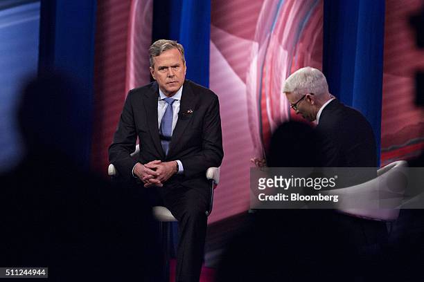 Jeb Bush, former Governor of Florida and 2016 Republican presidential candidate, left, listens during a town hall event hosted by CNN and anchor...