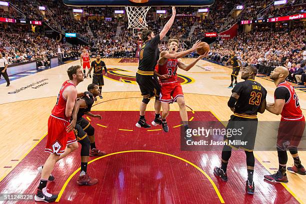 Mike Dunleavy of the Chicago Bulls shoots over Kevin Love of the Cleveland Cavaliers during the first half at Quicken Loans Arena on February 18,...