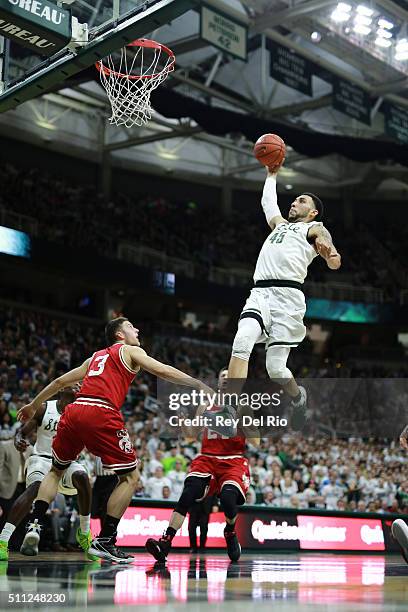Denzel Valentine of the Michigan State Spartans dunks the ball during the game against the Wisconsin Badgers in the second half at the Breslin Center...