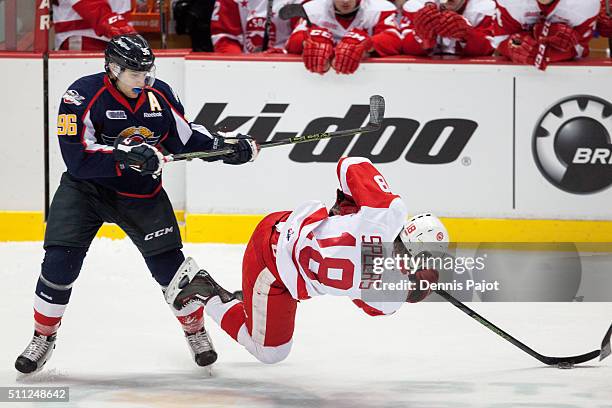 Forward Cristiano DiGiacinto of the Windsor Spitfires places a hit against forward Blake Speers of the Sault Ste. Marie Greyhounds on February 18,...