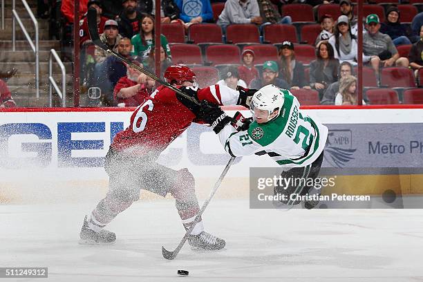 Antoine Roussel of the Dallas Stars attempts a shot past Michael Stone of the Arizona Coyotes during the third period of the NHL game at Gila River...