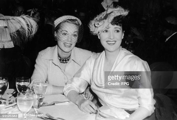 American actress June Havoc and her sister, actress, entertainer, and author Gypsy Rose Lee pose for photographers while dining at the Savoy Plaza,...