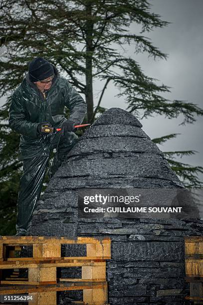 British artist Andy Goldsworthy works on an art installation in progess, "egg-shaped cairn of slates", at the Chateau de Chaumont-sur-Loire in...