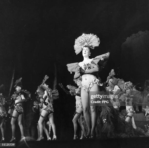American actress, entertainer, and author Gypsy Rose Lee sign on stage during a scene from 'Star & Garter' at the Music Box Theatre, New York, New...