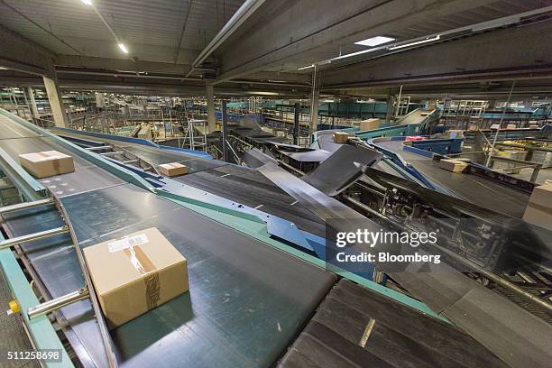 Parcels move along conveyors at a DHL parcel center, operated by Deutsche Post AG, in Saulheim, Germany, on Thursday, Feb. 18, 2016. Deutsche Post is...