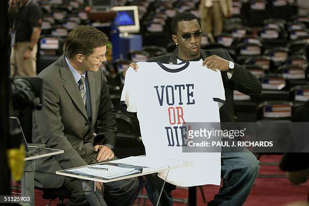 Hip-Hop star P-Diddy holds a "Vote or Die" T-Shirt during a television interview with CNN announcer Bill Hemmer 29 July 2004 on the floor of the...