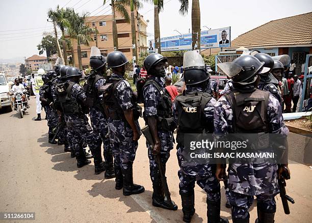 Uganda police block the gates of the opposition Forum for Democratic Change in Kampala on February 19 during events surrounding the arrest of...