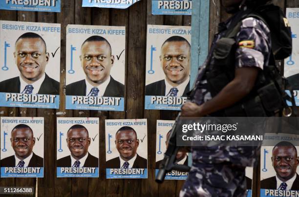 Ugandan police officer stands outside the gates of the opposition Forum for Democratic Change in Kampala on February 19 during events surrounding the...