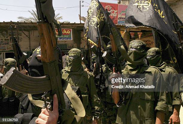 Members of Palestinian militant group Islamic Jihad are seen during the funeral of Palestinian militant, Mohamed Odwan, on July 29 in Rafah refugee...