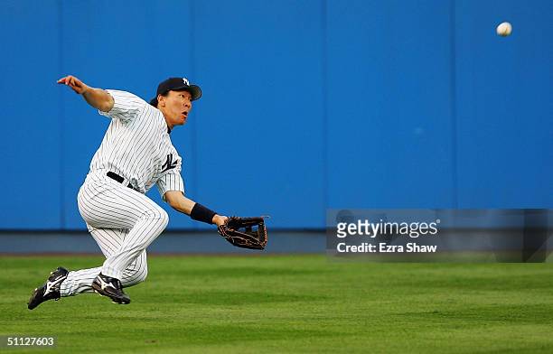 Hideki Matsui of the New York Yankees makes a diving catch on a ball hit by Karim Garcia of the Baltimore Orioles in the third inning on July 29,...