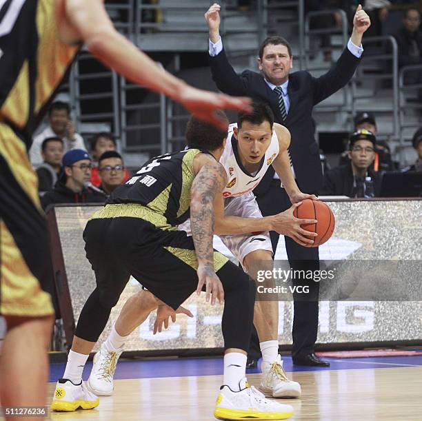 Michael Beasley of Shandong Golden Stars defends against Yi Jianlian of Guangdong Southern Tigers as Shandong head coach Aleksandar Kesar gestures...