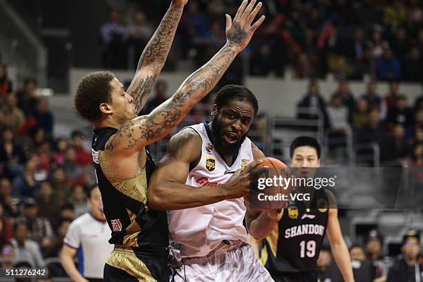 Michael Beasley of Shandong Golden Stars defends against Ike Diogu of Guangdong Southern Tigers during the Chinese Basketball Association 15/16...
