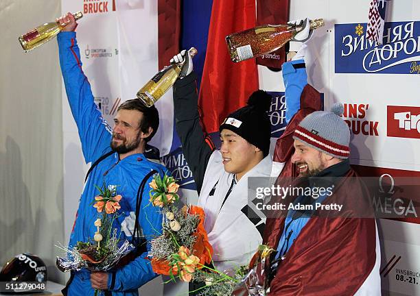 Martins Dukurs of Latvia celebrates victory, Yun Sungbin of Korea and Alexander Tretiakov of Russia tied second place after the Men's Skeleton during...