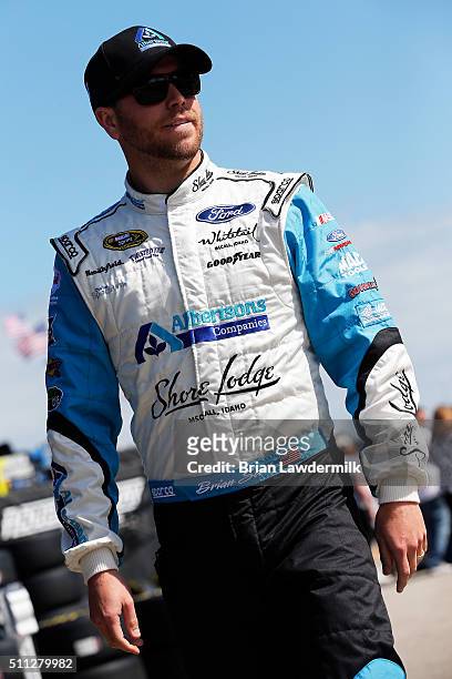 Brian Scott, driver of the Albertsons Co./Shore Lodge Ford, stands in the garage area during practice for the NASCAR Sprint Cup Series Daytona 500 at...