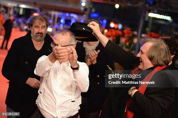 Dieter Kosslick and actor Gerard Depardieu, wearing Dieter Kosslick's scarrf, joke around prior the 'Saint Amour' premiere during the 66th Berlinale...