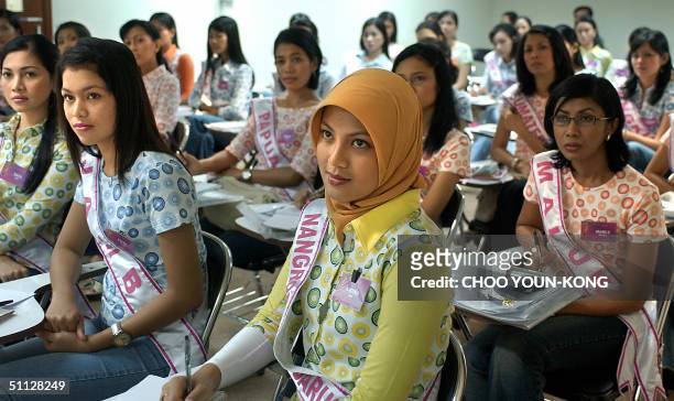 Indonesian Andina from the troubled Aceh province, studies how to make good make-up during a beauty contest of young women vying to be the next Miss...