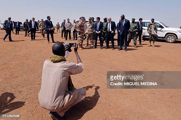 Malian journalist takes a picture of French Prime Minister Manuel Valls, France Defense Minister Jean-Yves Le Drian and Mali Defense Minister Tieman...