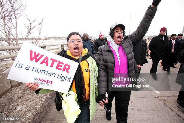 People participate in a national mile-long march to highlight the push for clean water in Flint February 19, 2016 in Flint, Michigan. The march was...