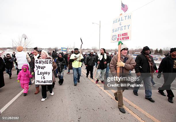 People participate in a national mile-long march to highlight the push for clean water in Flint February 19, 2016 in Flint, Michigan. The march was...