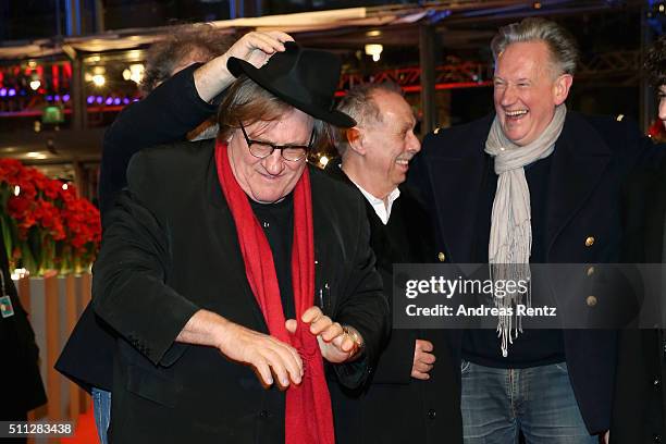 Gerard Depardieu, wearing Dieter Kosslick's scarf, glasses and hat, jokes around with Dieter Kosslick and director Benoit Delepine during the 'Saint...