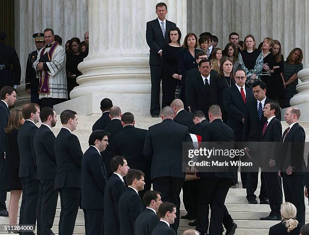 Father Paul Scalia , son of Associate Justice Antonin Scalia, watches as his fathers casket is carried up the steps of the Supreme Court building,...