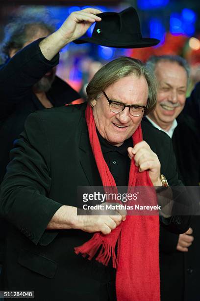 Gerard Depardieu, wearing Dieter Kosslick's scarf, jokes around with Dieter Kosslick and director Gustave Kervern during the 'Saint Amour' premiere...