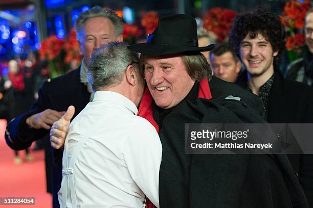 Dieter Kosslick and Gerard Depardieu, wearing Dieter Kosslick's hat and scarf, hug each other during the 'Saint Amour' premiere during the 66th...