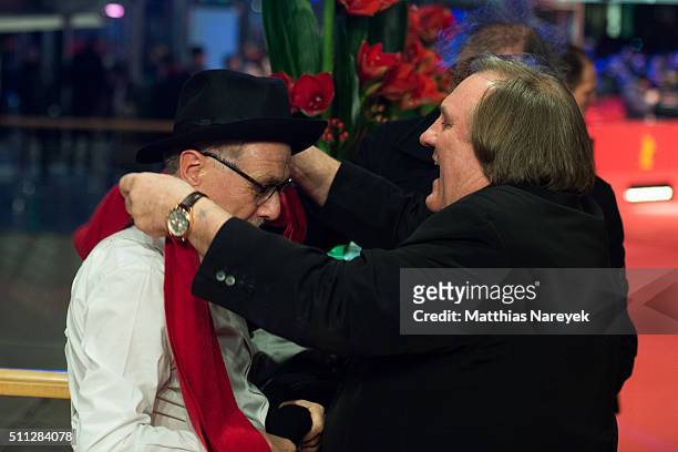 Gerard Depardieu takes Dieter Kosslicks's scarf during the 'Saint Amour' premiere during the 66th Berlinale International Film Festival Berlin at...