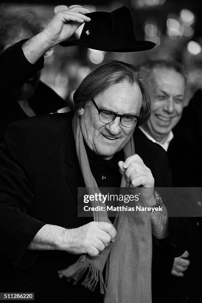 Gerard Depardieu, wearing Dieter Kosslick's scarf, jokes around with Dieter Kosslick and director Gustave Kervern during the 'Saint Amour' premiere...