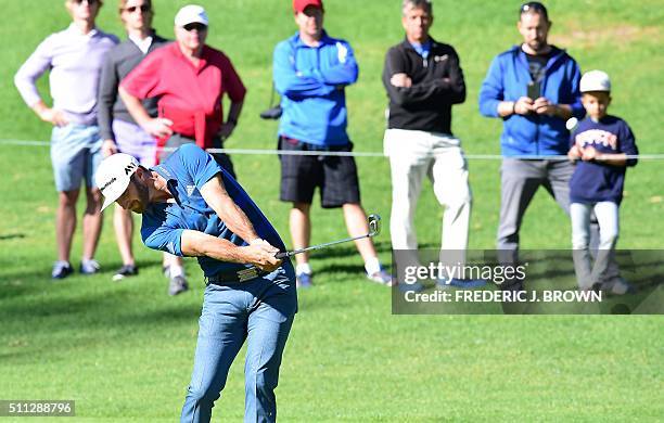 Dustin Johnson of the United States plays a shot to the green at the 18th hole on day two of the 2016 Northern Trust Open on February 19, 2016 at the...