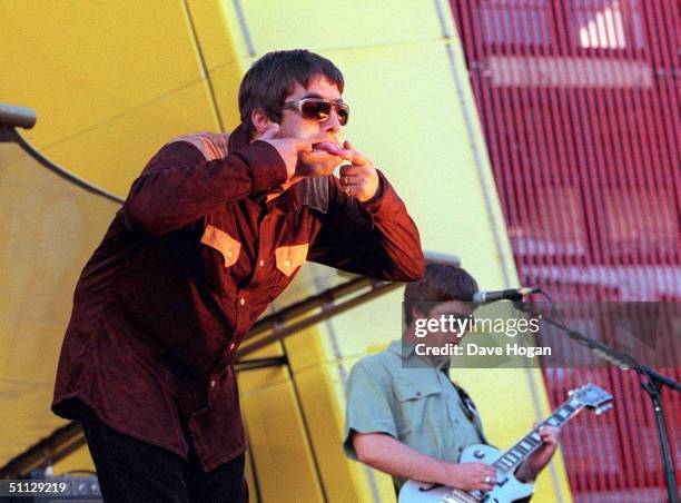 Singer Liam Gallagher and brother Noel Gallagher of band Oasis perform on stage in San Francisco supporting U2.