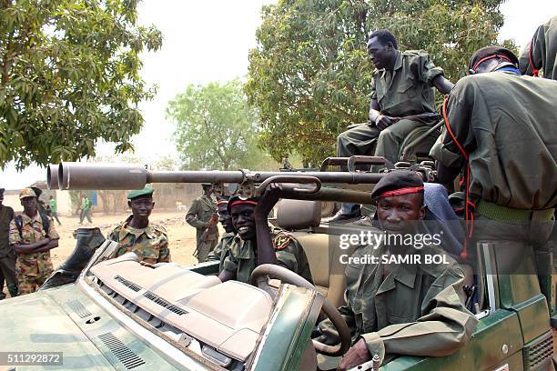 Picture taken on February 18, 2016 shows members of the Sudan People's Liberation Army riding on a vehicle with mounted artillery in Juba, as they...