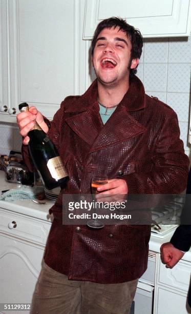 Singer Robbie Williams drinking at his home shortley after leaving Take That.