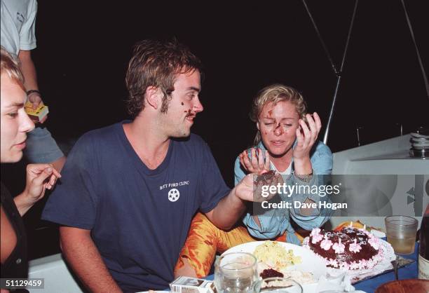 To R Jackie Hamilton Smith, singer Robbie Williams and Patsy Kensit celebrate Patys's birthday in Barbados.