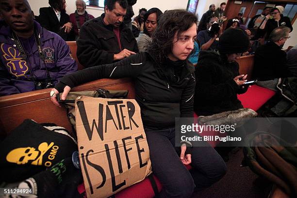 Woman attends a prayer service prior to participating in a national mile-long march to highlight the push for clean water in Flint February 19, 2016...