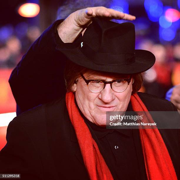 Actor Gerard Depardieu wears hat and scarf of festival director Dieter Kosslick as he attends the 'Saint Amour' premiere during the 66th Berlinale...