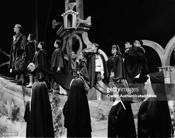 American actress Mary Martin leads the von Trapp children and their father, the Baron von Trapp, played Austrian actor Theodore Bikel , to safety as...