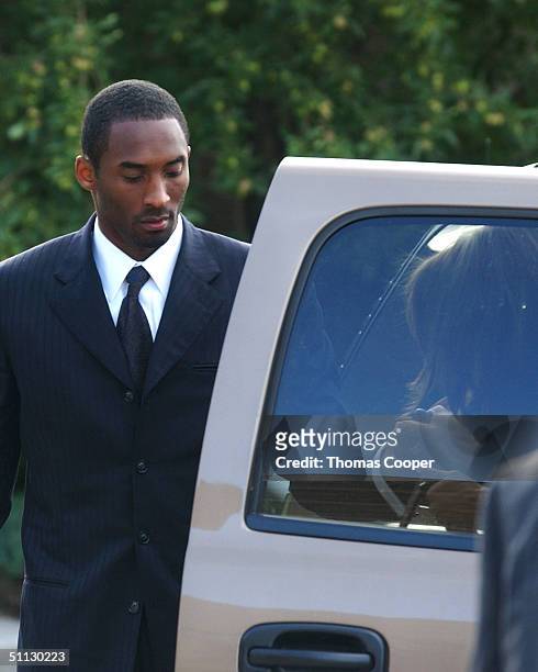Los Angeles Lakers star Kobe Bryant helps his attorney Pamela Mackey out of the SUV as they arrive at the Eagle County Justice Center for pre-trial...