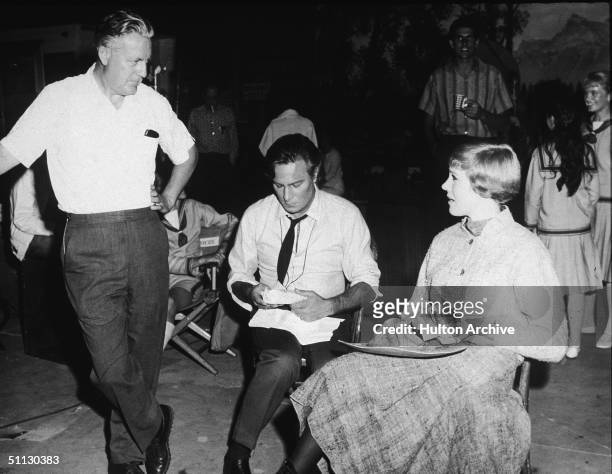 American film director Robert Wise , Canadian actor Christopher Plummer, and British actress Julie Andrews talk during a lunch break on the set of...
