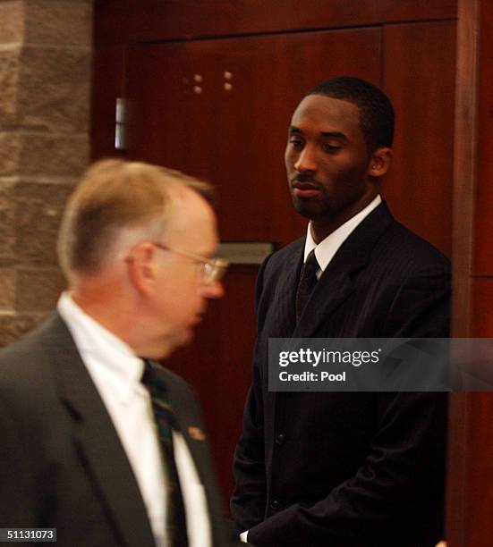 Los Angeles Lakers star Kobe Bryant along with security Ed Kilam leave the Eagle County Justice Center courtroom July 30, 2004 in Eagle, Colorado. On...
