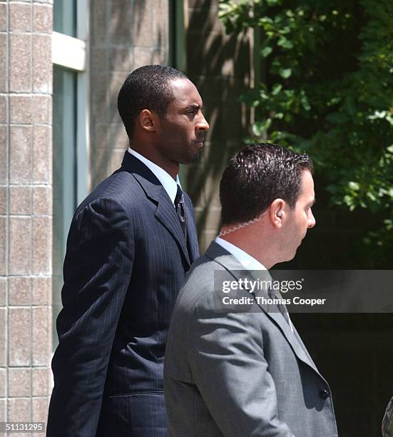 Los Angeles Lakers star Kobe Bryant along with his security, Jose Revilla, leave the Eagle County Justice Center after pre-trial hearings July 30,...