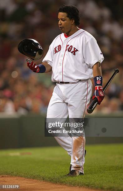 Manny Ramirez of the Boston Red Sox walks on the field with his bat and helmet during the game against the New York Yankees at Fenway Park on July...