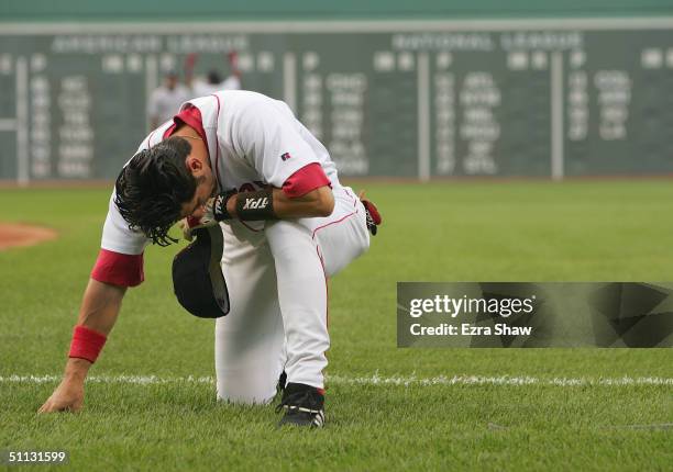 Nomar Garciaparra of the Boston Red Sox goes down to one knee dejected during the game against the New York Yankees at Fenway Park on July 23, 2004...